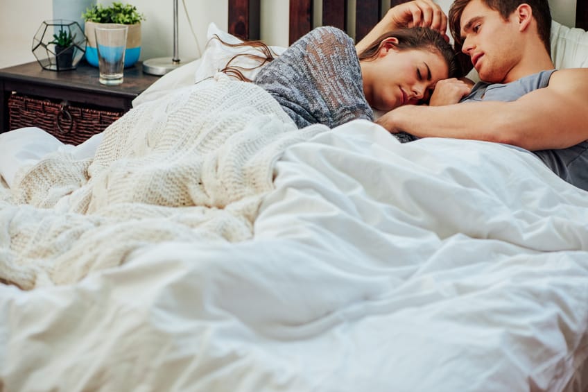 couple bed cuddling romance home comfort