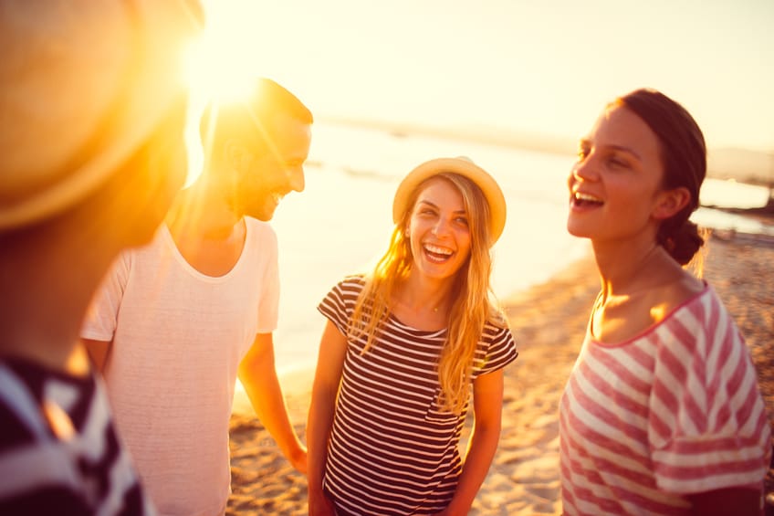 couple beach friends party sunset