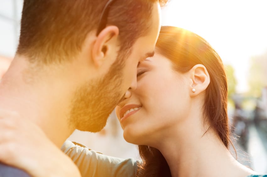 couple kissing beach sunset romance