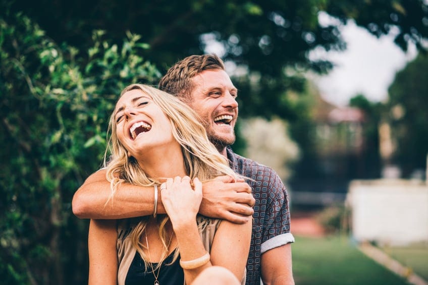couple close laughing outdoors