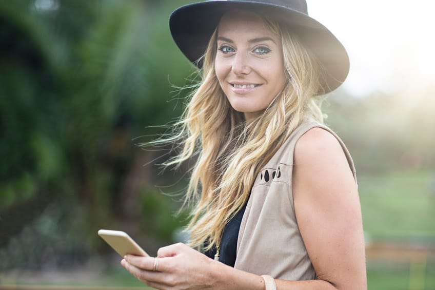 woman phone text sunshine outside