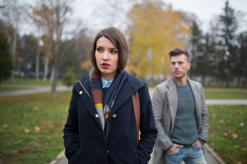 woman walking away from man couple fight