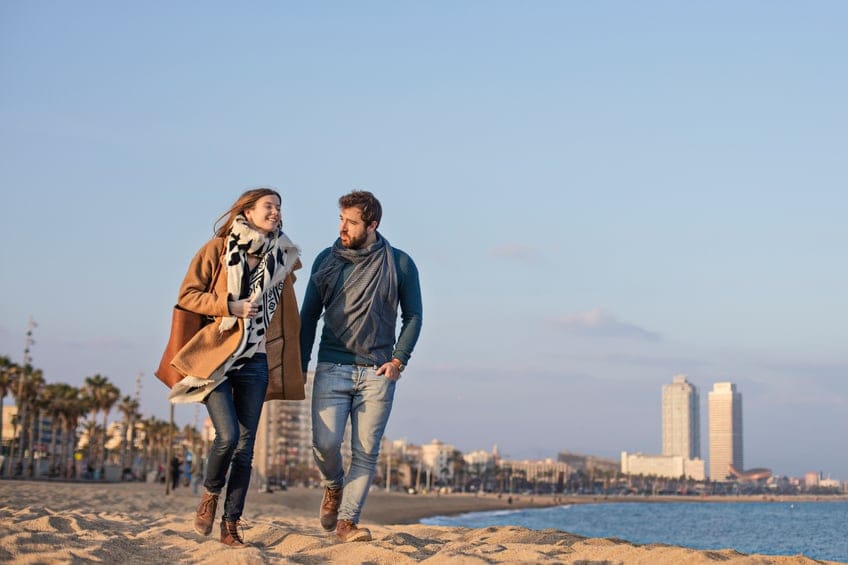 couple walking beach romance winter