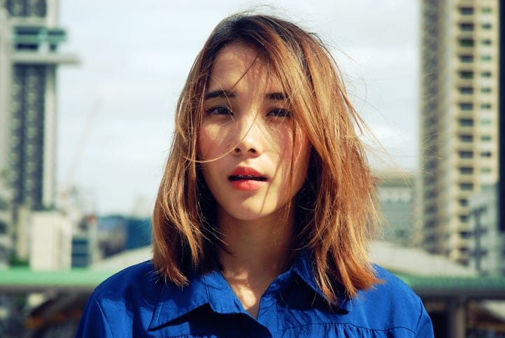 serious young asian girl looking at camera