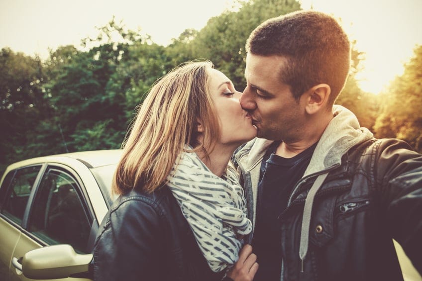 couple kissing outdoors romance
