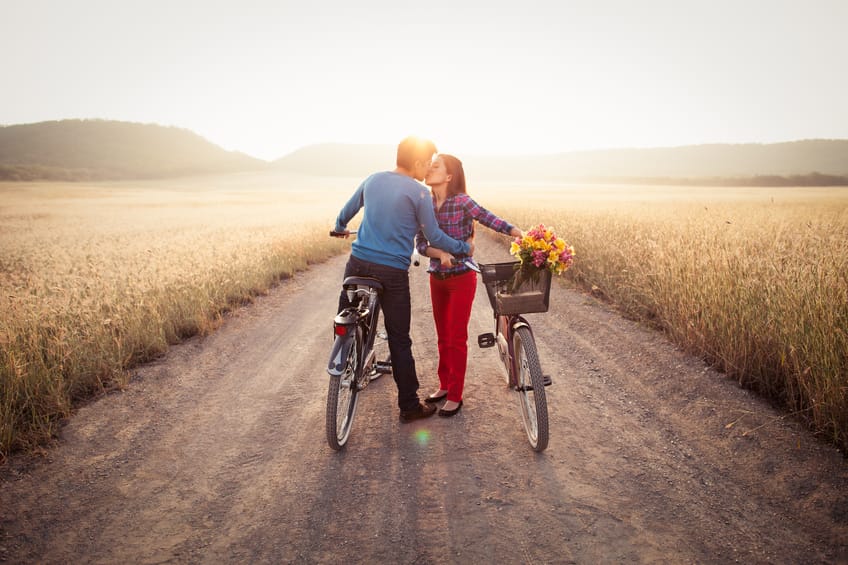 couple kiss bike sunset romance