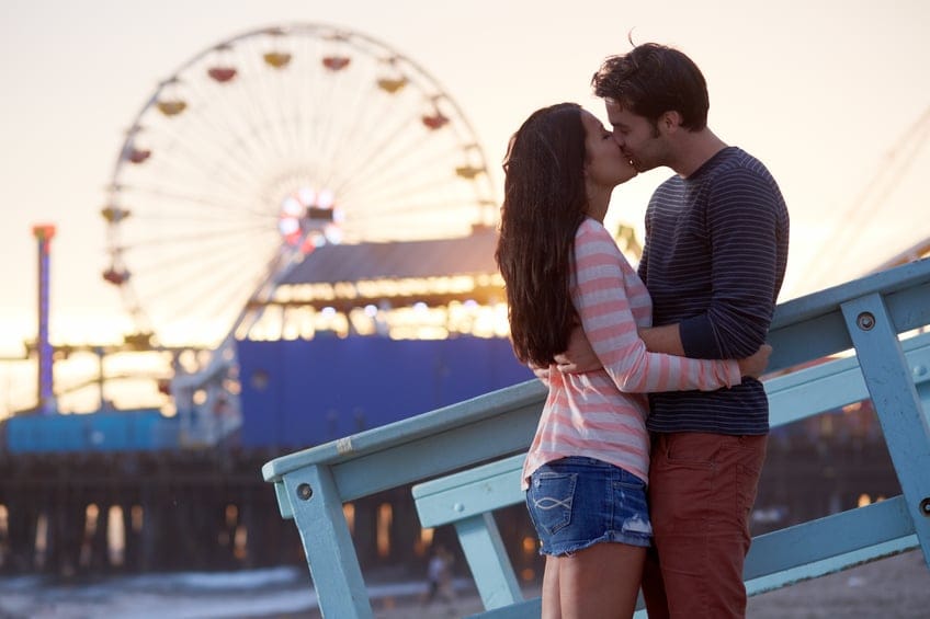 romantic couple kissing at sunset