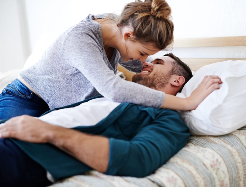 couple kissing bed romance intimacy