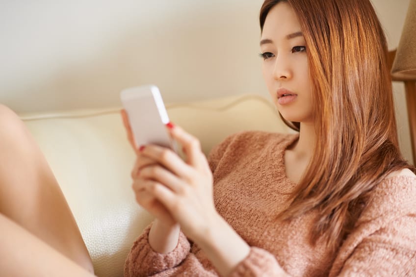young woman phone texting couch