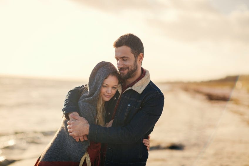 Photo of a lovely couple walking on the beach