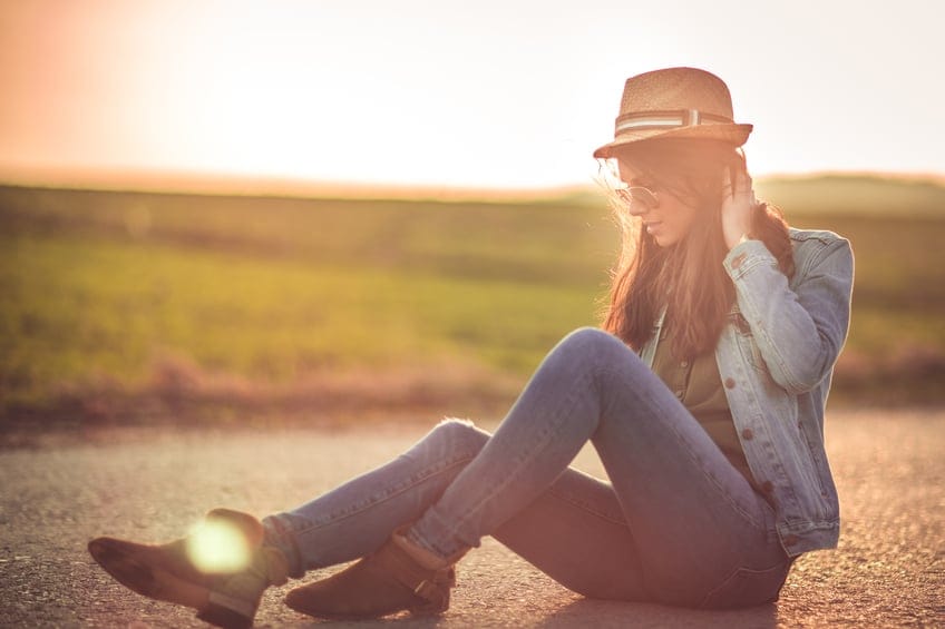 Beautiful girl on rural road in nature