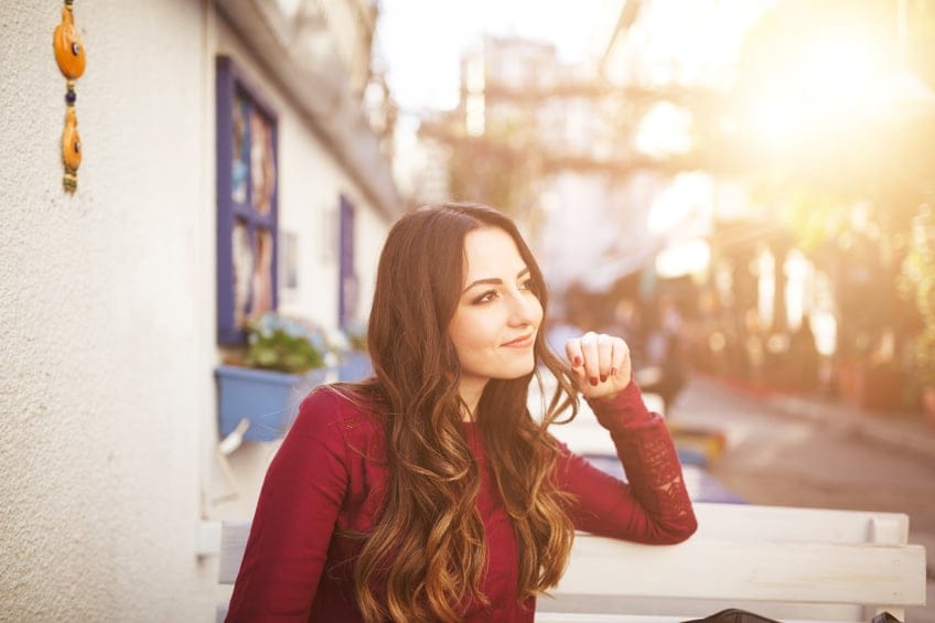 Young beautiful woman thinking sitting a cafe.