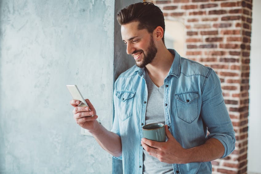 Young hipster wall texting