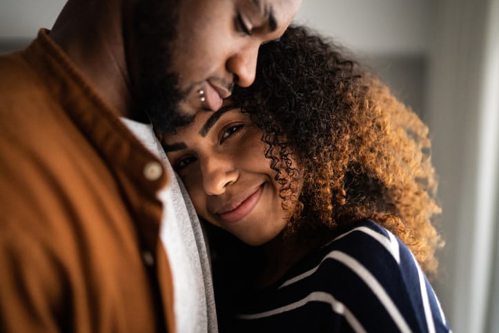 smiling couple cuddling close-up