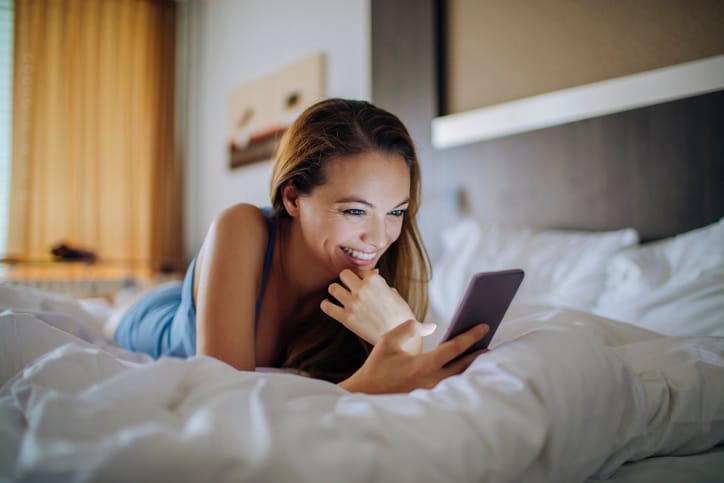 Close up photo of a young woman using a smart phone