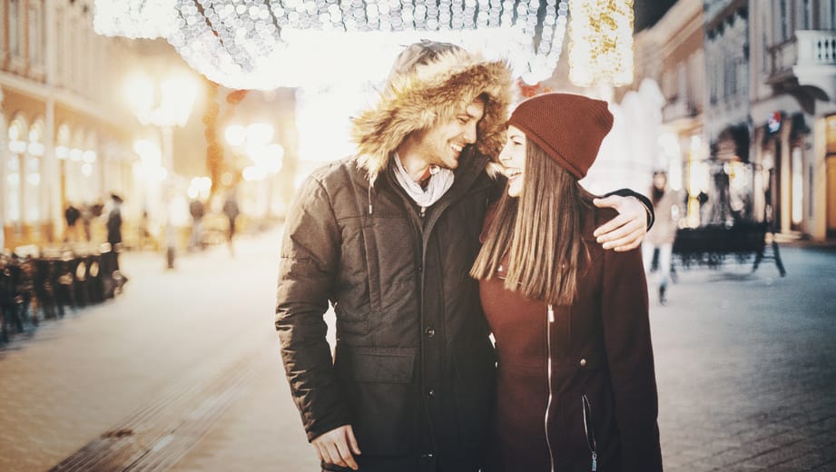 Couple having romantic walk on winter night.