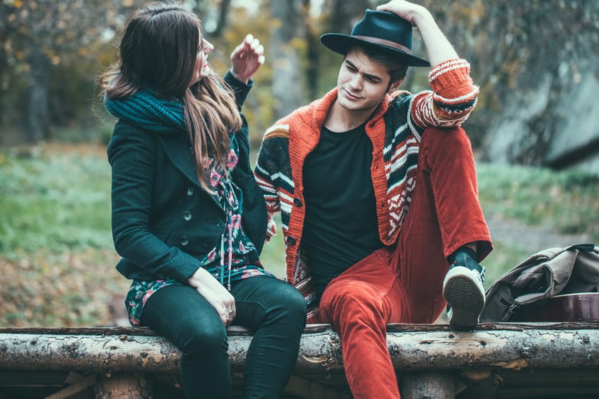 Young hipster couple, boyfriend and a girlfriend enjoying the cold weather outside of the house.