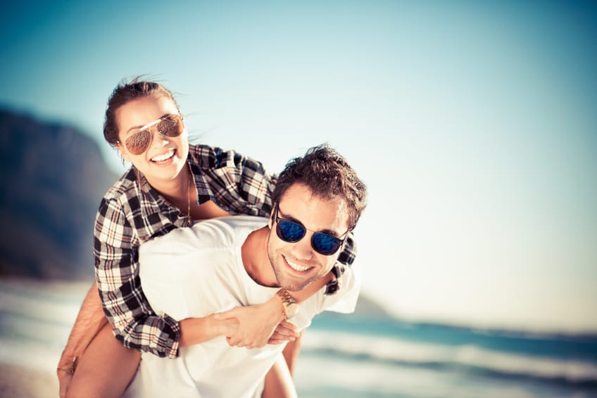 happy couple laughing beach romance love