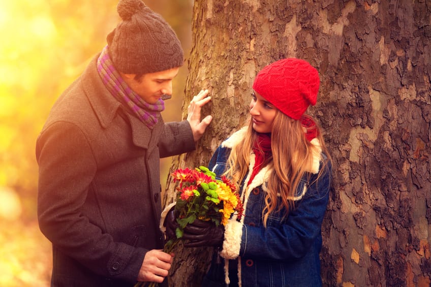 young couple in the nature with a boquet of flowers