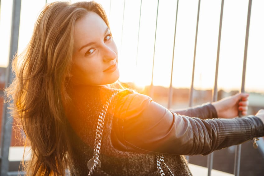 young woman attitude portrait sun outdoors city