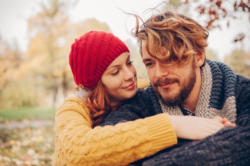 Young couple enjoying in park in autumn.