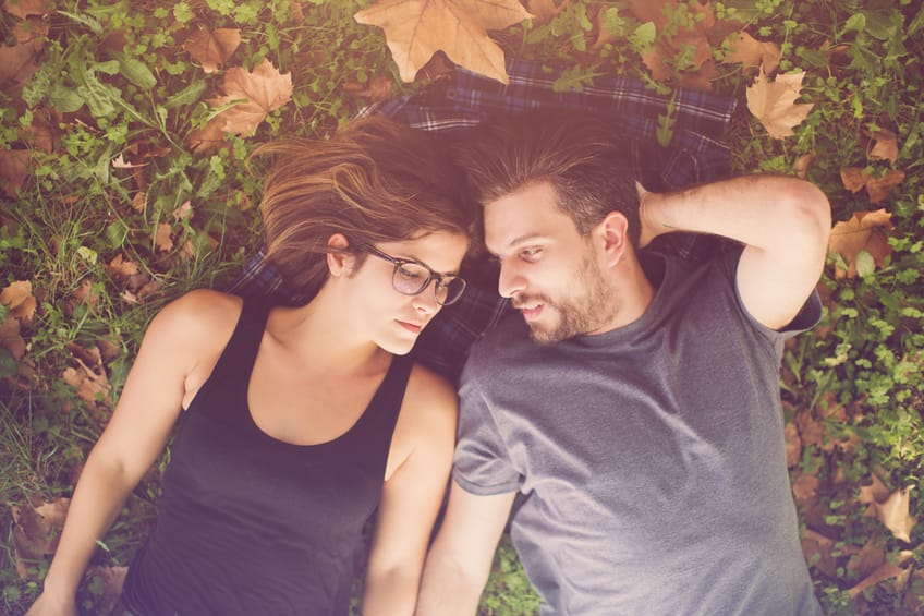 Happy couple lying on the grass