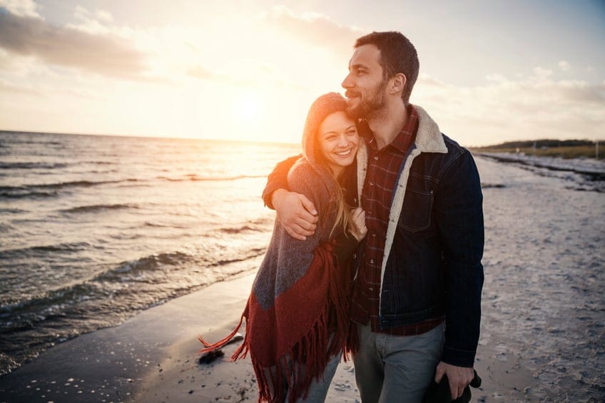 couple walking beach romance happy
