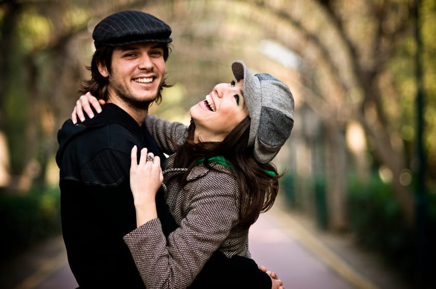A couple enjoying each other on a walk in the woods