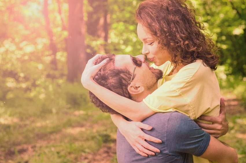 man lifting woman kissing
