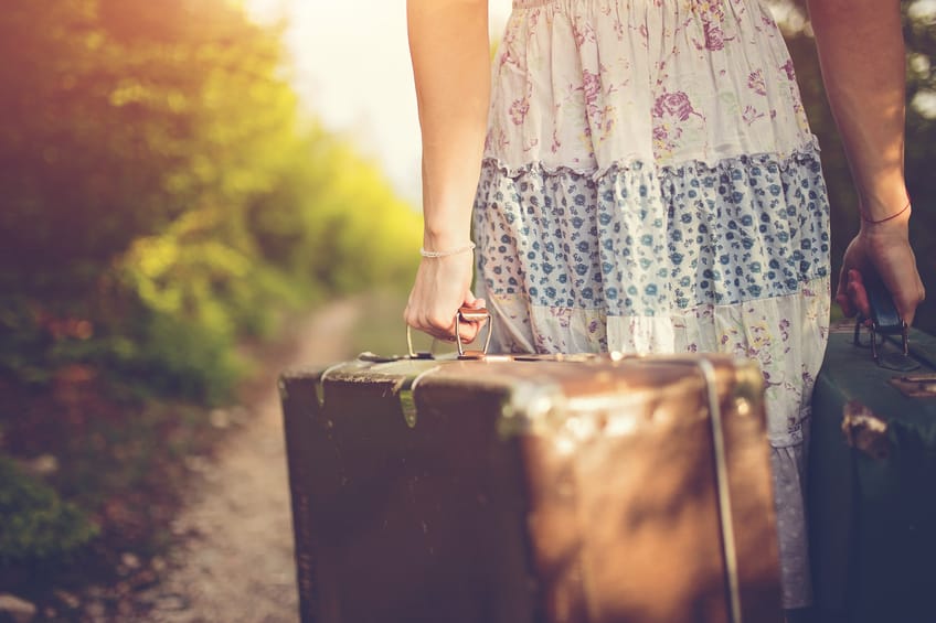 Photo of woman's hand holding traveling bag