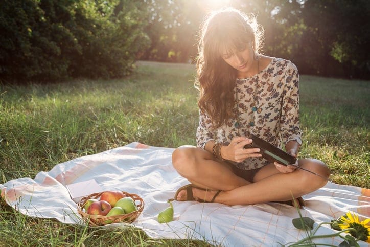 young woman happy alone picnic park sun