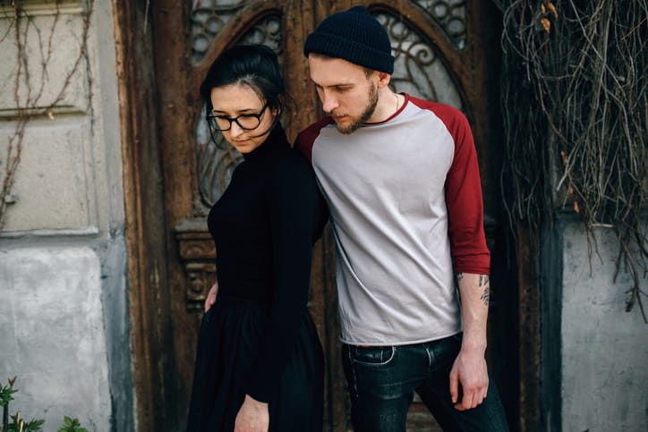 young beautiful couple posing on the background of an old building