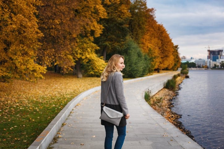Woman walking in autumn in the park.