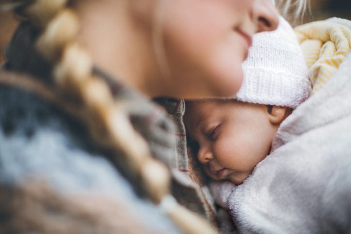 Mother and her newborn son in autumn park