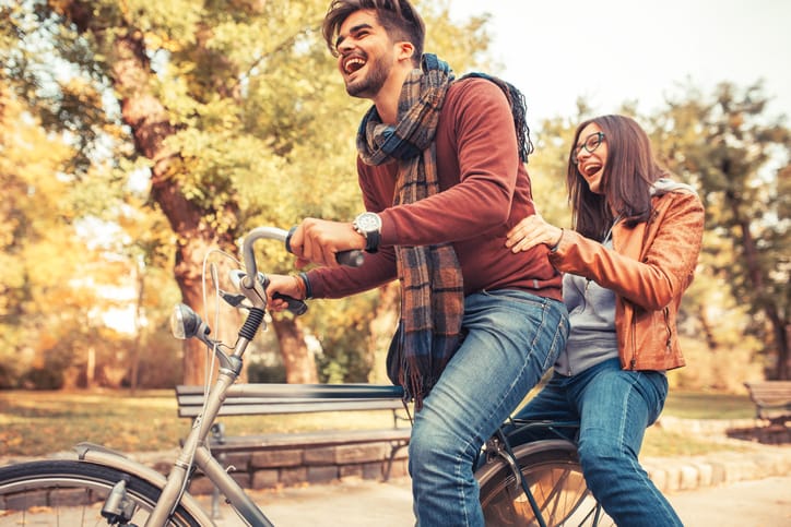 Young couple riding bicycle