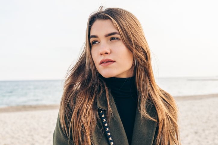thoughtful woman on the beach