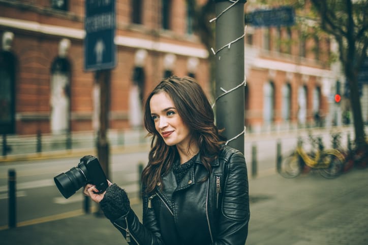 young woman happy camera outdoors city