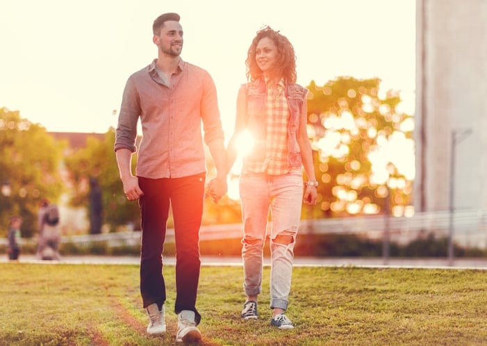 young couple happy walking sunset