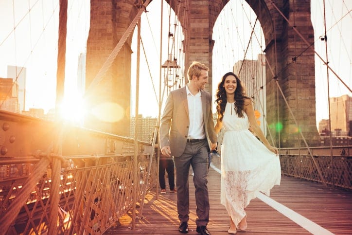 Couple running on Brooklyn Bridge