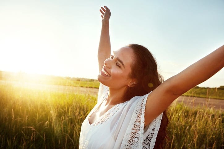 Shot of an attractive young woman standing outside in a field