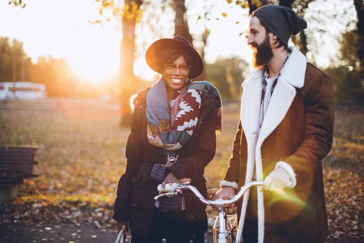 Couple with bicycle in park