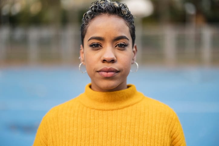 serious woman with yellow sweater