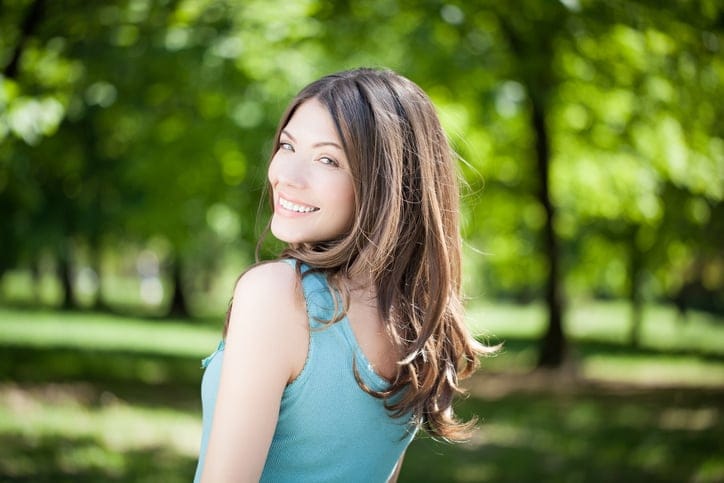 Beautiful young woman posing outdoors on a summer day.