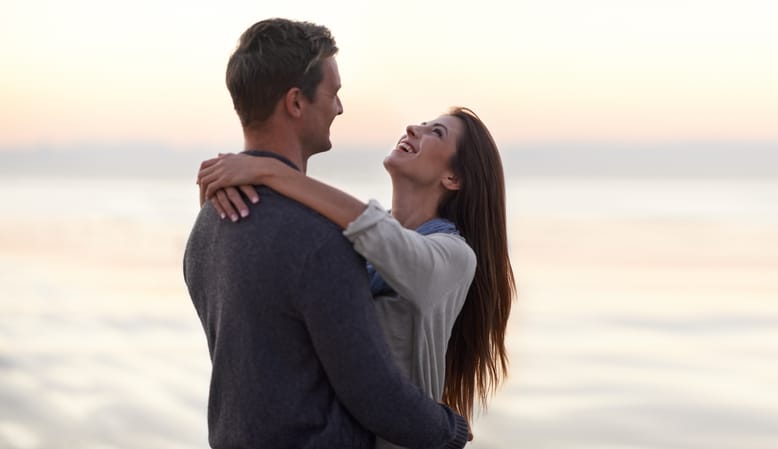 A young couple enjoying a romantic walk on the beach