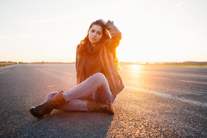 young caucasian woman portrait at sunset, back lit