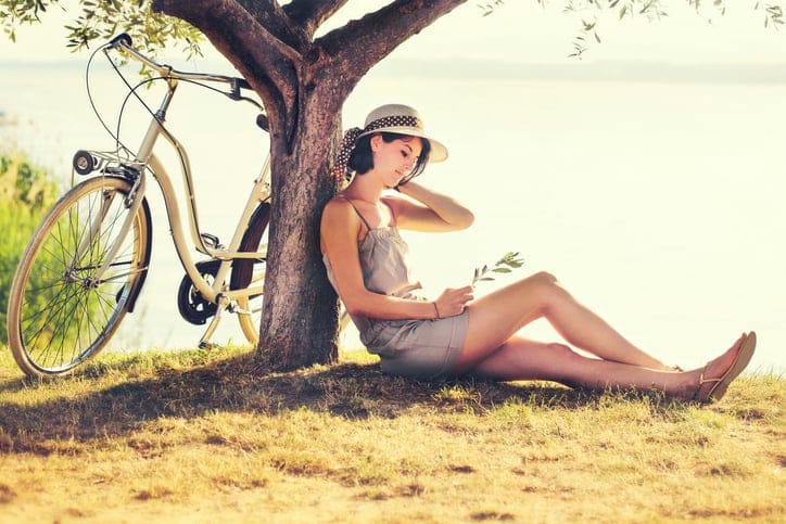 Beautiful dormant woman in love waiting under an olive's tree