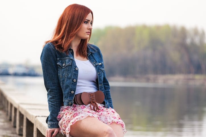 Girl sitting by the river