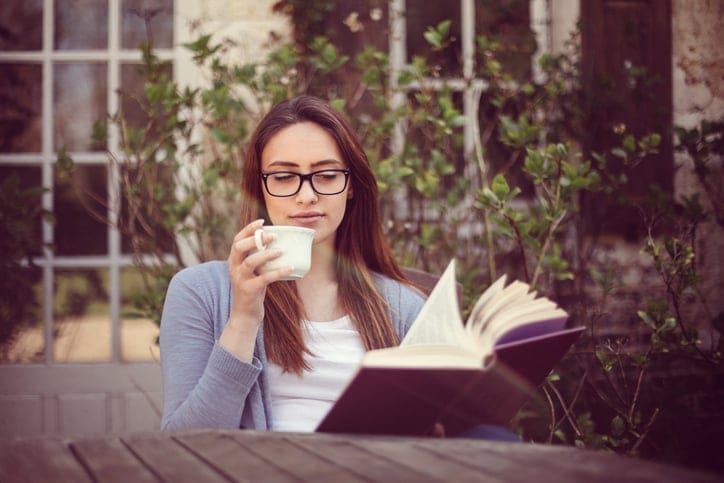 Woman resting and reading a book outside
