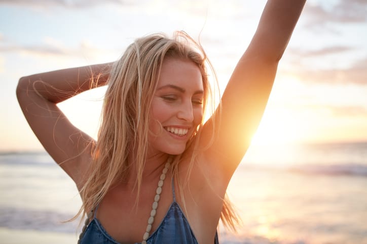 young woman happy beach sunset