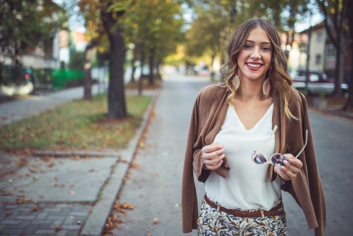 A beautiful young foman walking on the street on a beautiful autumn day